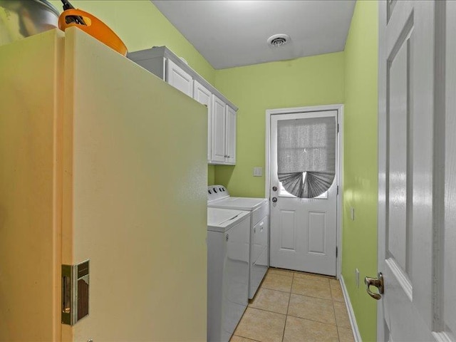 laundry room featuring visible vents, baseboards, light tile patterned flooring, cabinet space, and separate washer and dryer