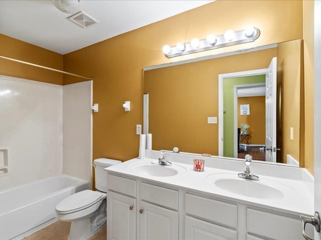 full bath featuring double vanity, visible vents, toilet, and a sink