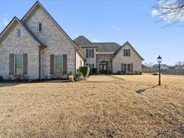 view of front facade featuring stone siding and a front yard