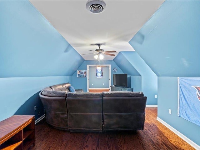 living room featuring visible vents, lofted ceiling, a ceiling fan, wood finished floors, and baseboards