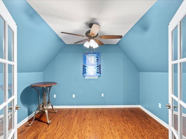 additional living space with french doors, baseboards, lofted ceiling, and wood finished floors