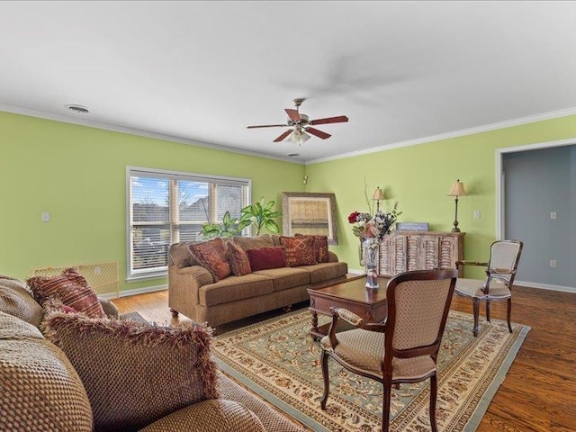 living area featuring visible vents, a ceiling fan, wood finished floors, and crown molding