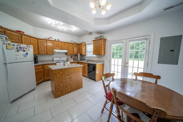 kitchen featuring visible vents, electric panel, under cabinet range hood, white appliances, and a raised ceiling