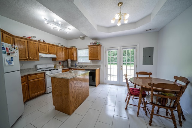 kitchen featuring under cabinet range hood, french doors, white appliances, and brown cabinetry