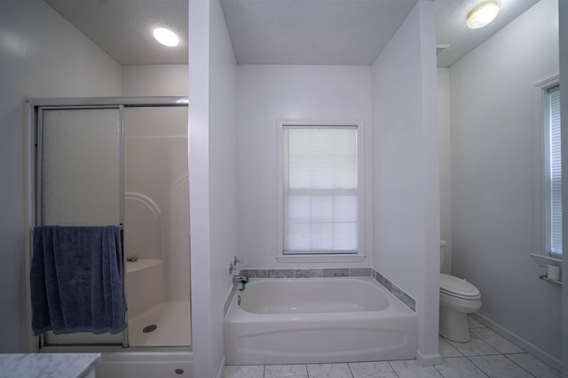 bathroom featuring a shower stall, baseboards, toilet, a garden tub, and a textured ceiling