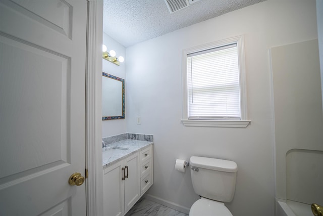 bathroom with vanity, baseboards, a textured ceiling, toilet, and marble finish floor