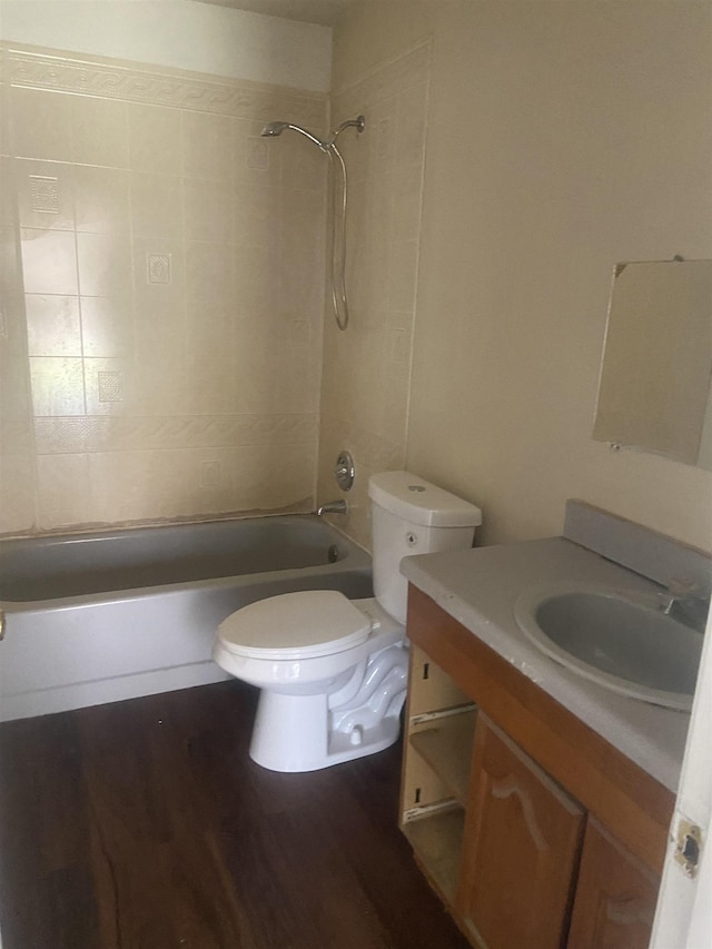 bathroom featuring vanity, shower / tub combination, toilet, and wood finished floors