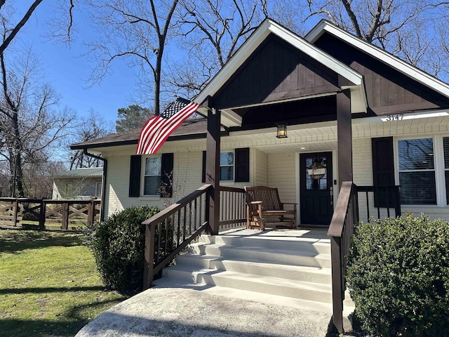 bungalow-style house featuring brick siding, a porch, and a front lawn