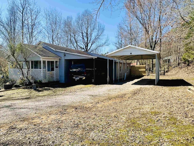 view of home's exterior with a carport and driveway