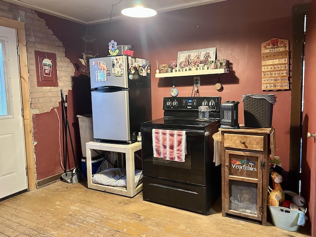 kitchen with electric range, crown molding, freestanding refrigerator, and wood-type flooring