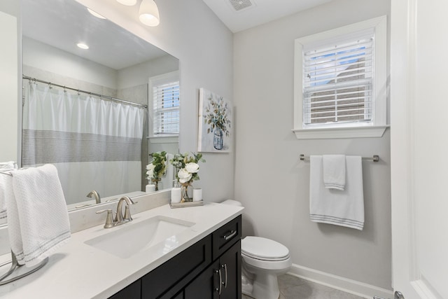 full bathroom featuring vanity, visible vents, baseboards, tile patterned floors, and toilet