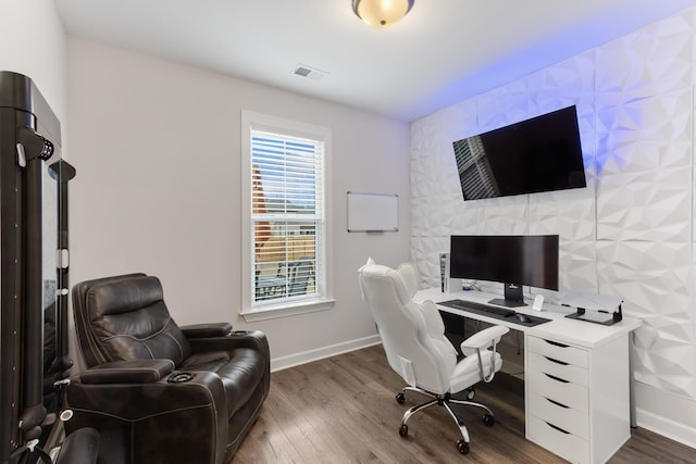 office featuring visible vents, baseboards, and wood finished floors