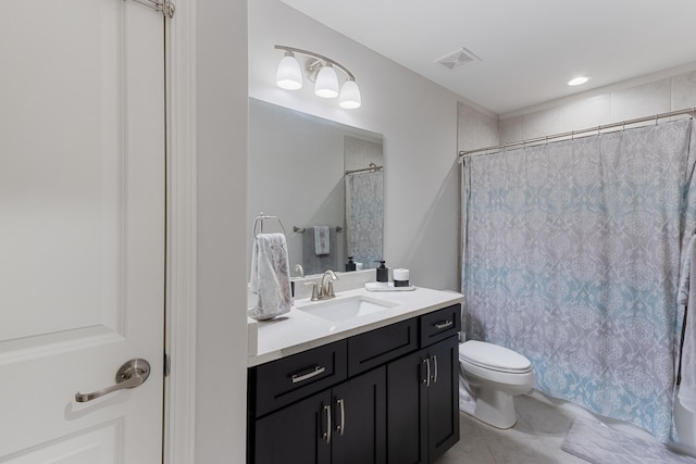 bathroom featuring vanity, a shower with shower curtain, visible vents, tile patterned floors, and toilet