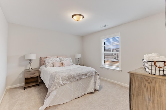 bedroom featuring baseboards, visible vents, and light carpet