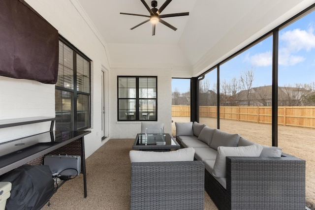 sunroom / solarium with a wealth of natural light, ceiling fan, and vaulted ceiling