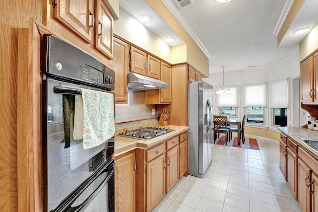 kitchen with light tile patterned floors, light countertops, appliances with stainless steel finishes, under cabinet range hood, and backsplash