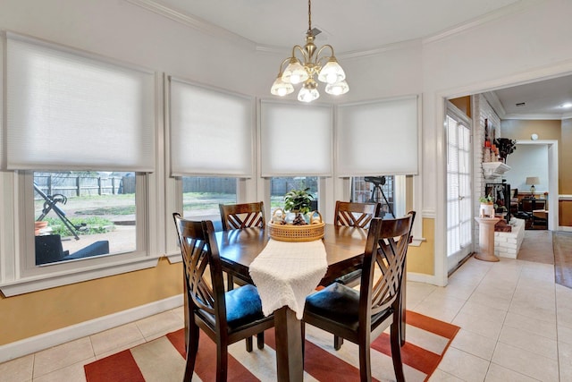 dining room featuring light tile patterned flooring, a chandelier, baseboards, and ornamental molding