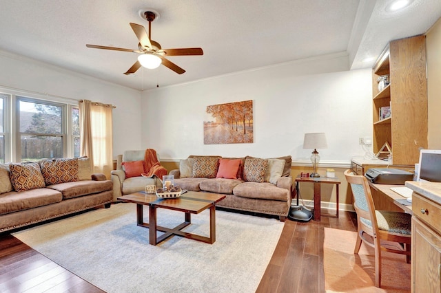 living room with a ceiling fan, baseboards, light wood finished floors, and ornamental molding