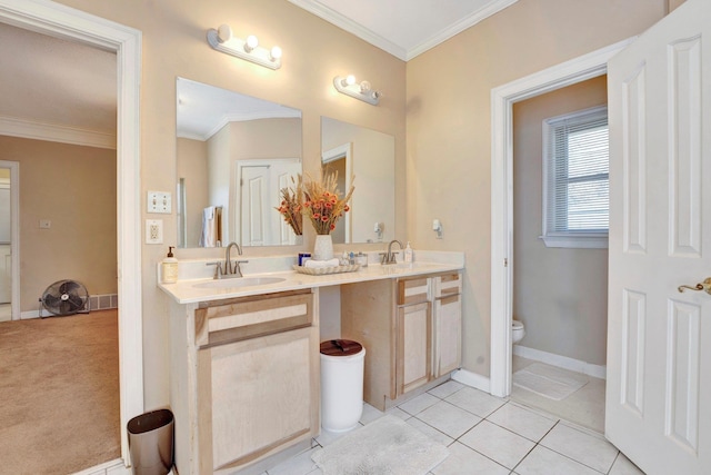 bathroom with tile patterned floors, ornamental molding, and a sink