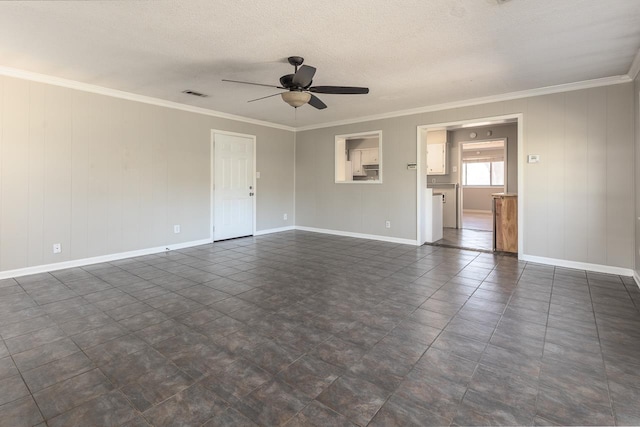 empty room featuring a textured ceiling, ornamental molding, visible vents, and ceiling fan