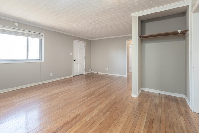 unfurnished bedroom featuring a closet, light wood-type flooring, baseboards, and ornamental molding