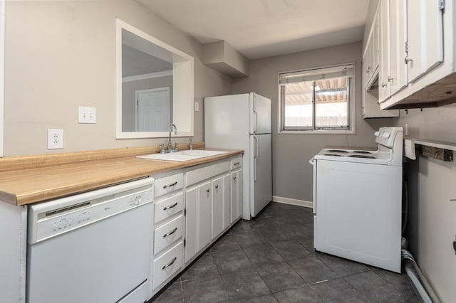 kitchen with white cabinetry, white appliances, light countertops, and a sink