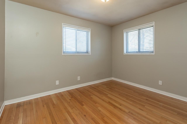 empty room with light wood-type flooring and baseboards