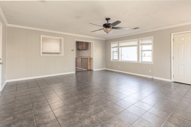 unfurnished living room with visible vents, a ceiling fan, baseboards, and ornamental molding