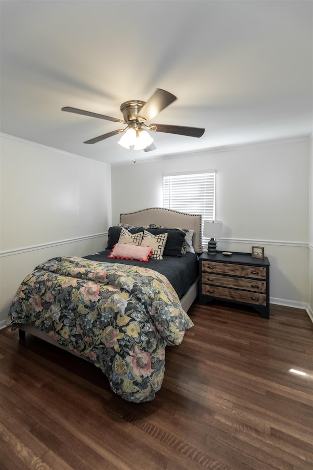 bedroom with ceiling fan, baseboards, wood finished floors, and ornamental molding