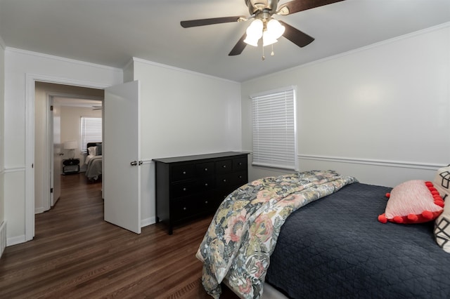 bedroom with ornamental molding, a ceiling fan, and dark wood-style flooring