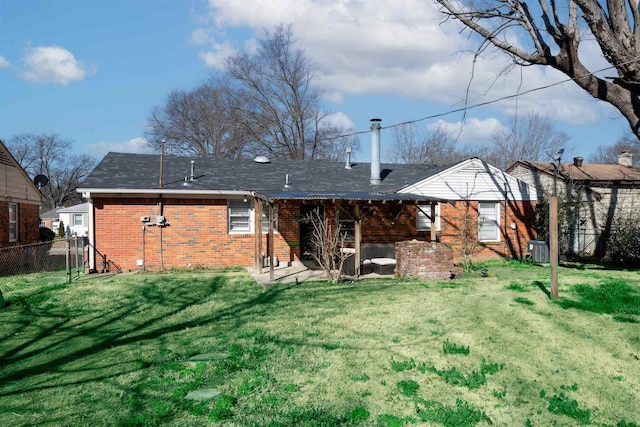 back of property featuring a patio, a yard, fence, and brick siding