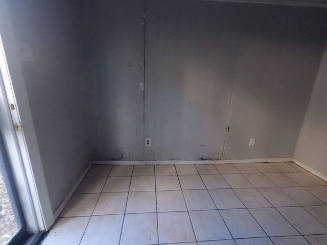 unfurnished room with baseboards