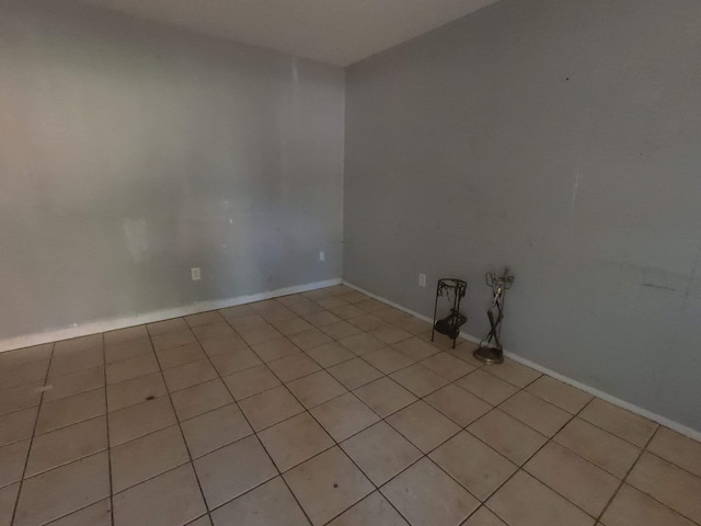 unfurnished room featuring baseboards