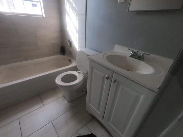 bathroom with tile patterned floors, washtub / shower combination, toilet, and vanity