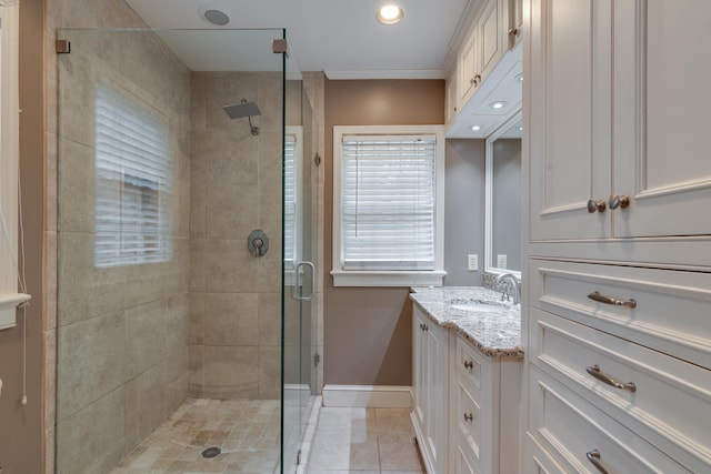 full bathroom with tile patterned floors, a shower stall, vanity, and baseboards