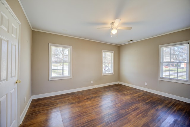 unfurnished room with dark wood finished floors, a ceiling fan, baseboards, and ornamental molding