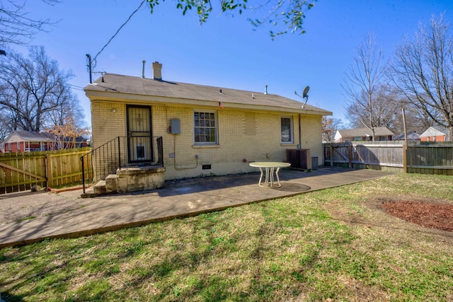 back of house with a patio, a chimney, crawl space, fence private yard, and brick siding