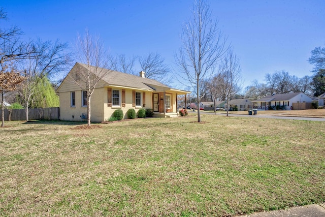 view of property exterior featuring fence, a chimney, crawl space, a lawn, and brick siding