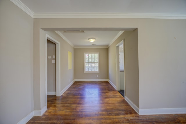 hall featuring crown molding, baseboards, and wood finished floors