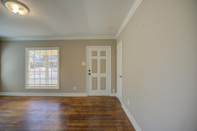 entryway featuring baseboards, wood finished floors, and crown molding