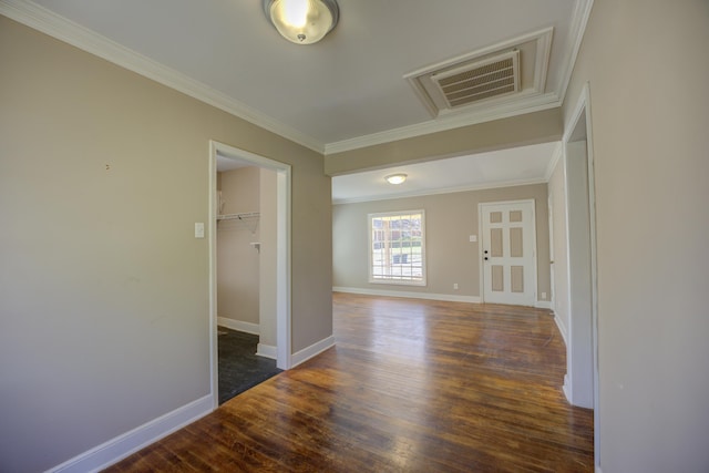 hall with visible vents, wood finished floors, and crown molding