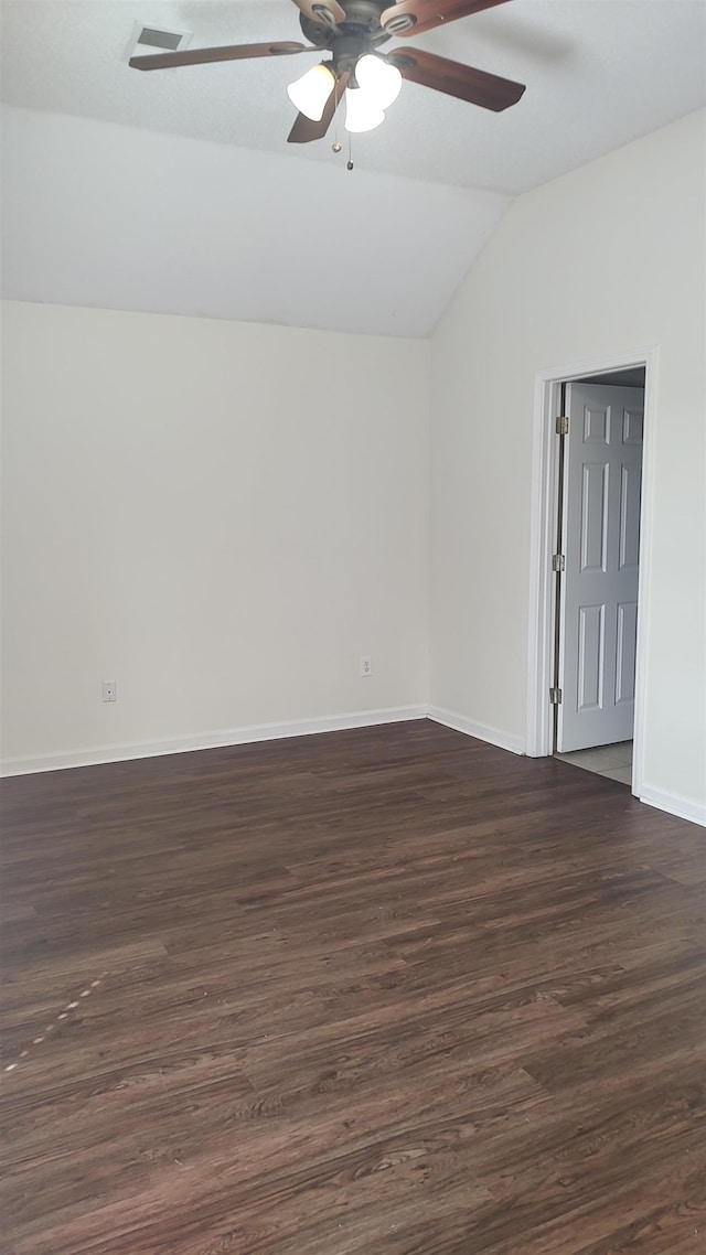 spare room with dark wood finished floors, lofted ceiling, baseboards, and ceiling fan