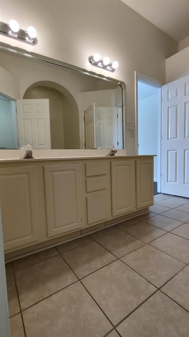 bathroom with tile patterned floors, double vanity, and a sink