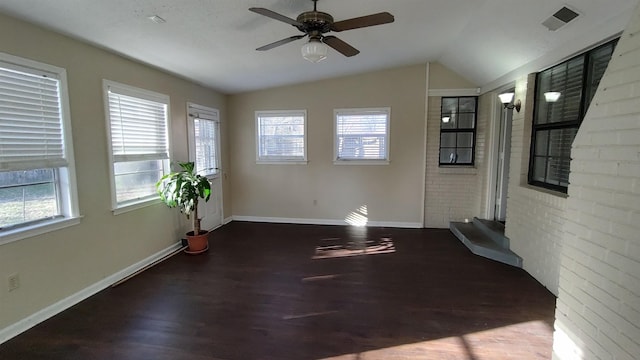 unfurnished room with wood finished floors, baseboards, visible vents, lofted ceiling, and ceiling fan