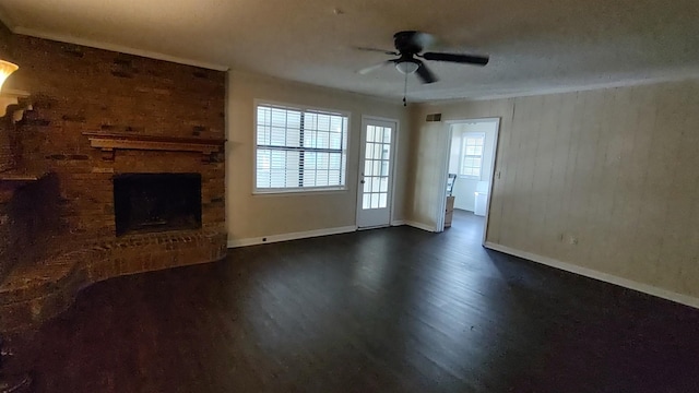 unfurnished living room with dark wood finished floors, a fireplace, baseboards, and a ceiling fan