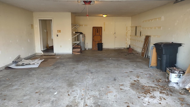 garage featuring a garage door opener and electric water heater