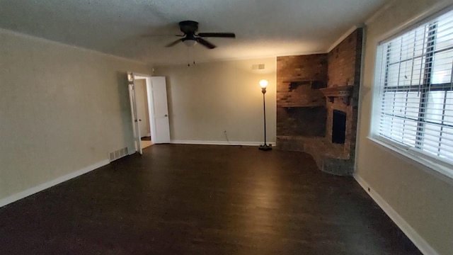 unfurnished living room with a brick fireplace, visible vents, and baseboards