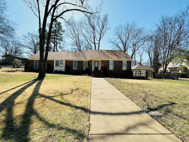 view of front of property featuring a front yard and brick siding