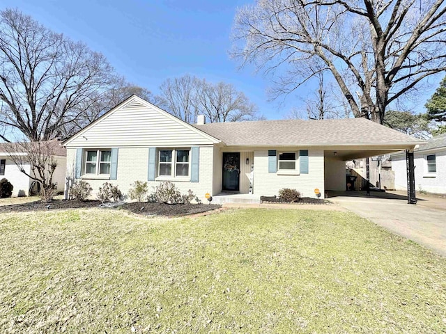 single story home with an attached carport, a front yard, driveway, a chimney, and brick siding