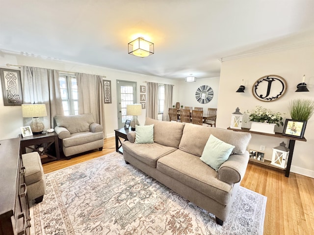 living room featuring plenty of natural light, wood finished floors, and baseboards